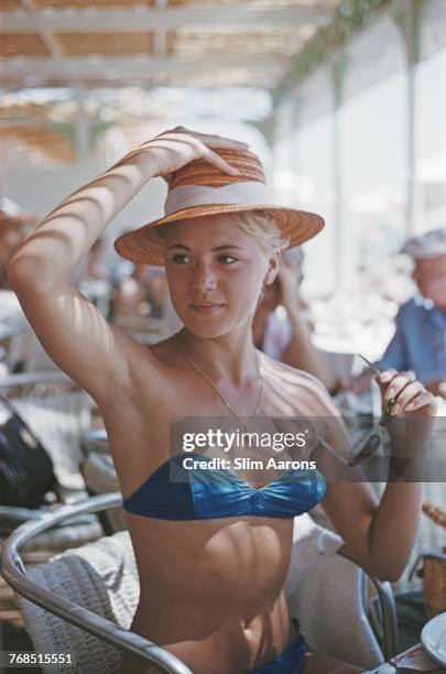 Guest relaxes at the Carlton Hotel, Cannes, France, July 1958.