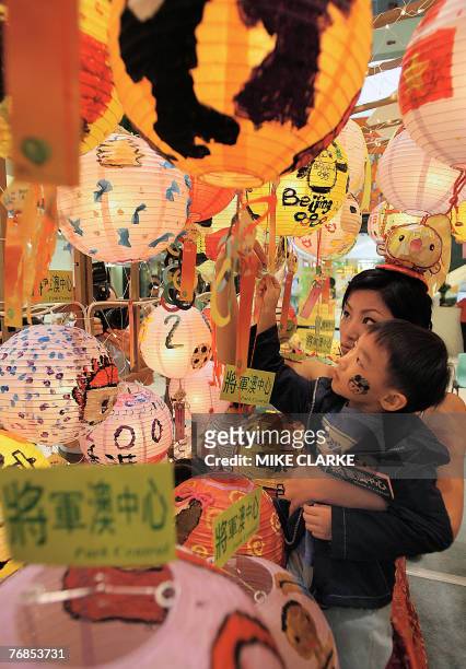 Boy who had taken part in a lantern design competition to celebrate Mid Autumn Festival look up at creations at a shopping mall in Hong Kong 18...
