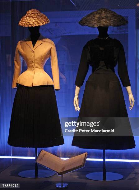 Classic 'Bar' suit and hat and a Maxim's restaurant dress and hat both by Christian Dior from 1947 are displayed at the Golden Age of Couture...