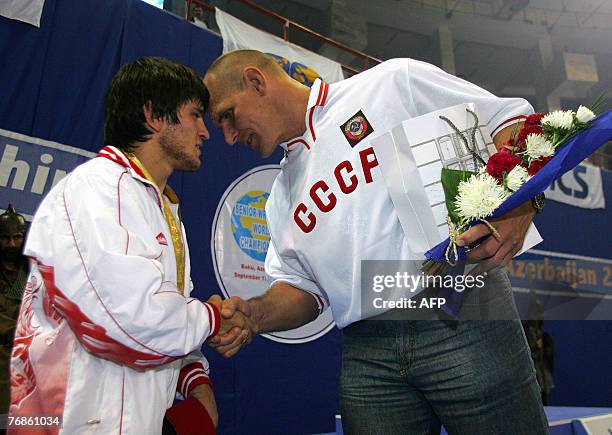 Maviet Batirov of Russia is congratulated by Russian wrestling legend Alexander Karelin in Baku, 19 September 2007. Baku, the capital city of...