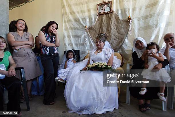 Waed Mundar, a 25-year-old Druze bride, is surrounded by crying relatives who know she may never see her family again during wedding celebrations at...