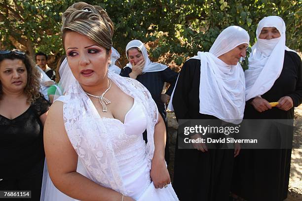 Waed Mundar, a 25-year-old Druze bride, greets crying relatives at her family home September 19, 2007 in her village of Ein Qiniya in the Golan...