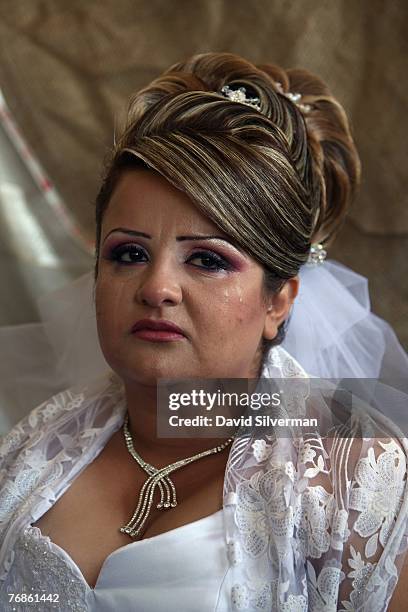 Waed Mundar, a 25-year-old Druze bride, cries knowing she may never see her family again during wedding celebrations at her home September 19, 2007...