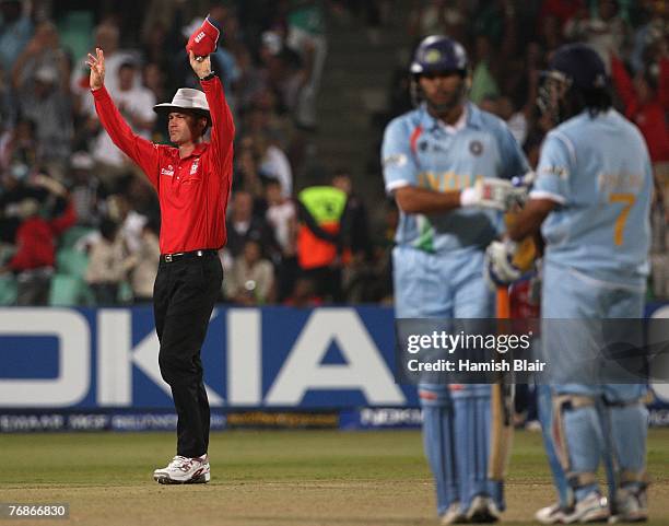 Umpire Simon Taufel signals one six consecutive sixes from Yuvraj Singh of India during one over from Stuart Broad of England during the ICC Twenty20...