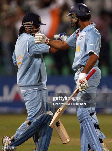 Indian cricket team player Yuvraj Singh celebrates his quickest half century with team captain Mahendra Singh Dhoni in the ICC World Twenty20 match...