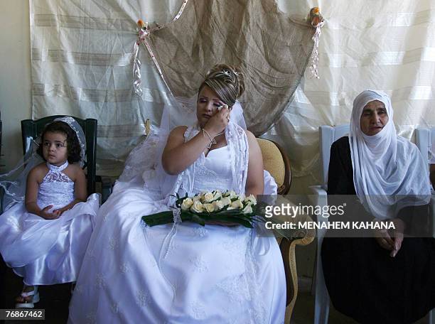 Waed Mundar, a 25-year-old Druze bride, is surrounded by relatives who know she may never see her family again during wedding celebrations at her...