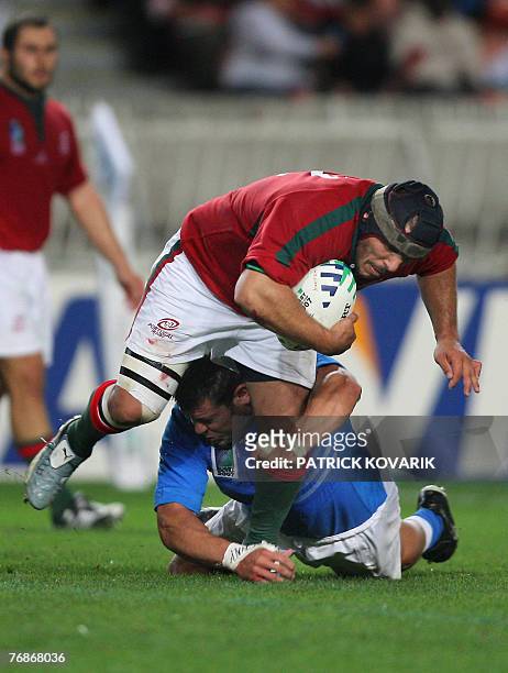 Portugal's hooker Joao Correia is tackled by Italy's prop Andrea Lo Cicero during their rugby union World Cup group C match Italy vs. Portugal, 19...