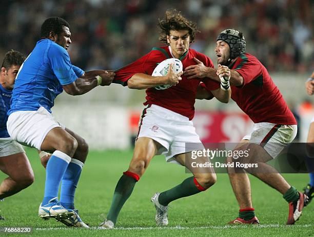 Antonio Aguilar of Portugal has his shirt pulled by Manoa Vosawai of Italy during the Rugby World Cup 2007 Pool C match between Italy and Portugal at...