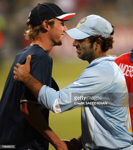 Indian cricket team player Yuvraj Singh smiles while being greeted by England's fast bowler Stuart Broad who he hit for 6 sixes in an over 19...