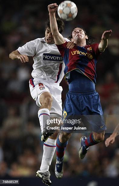 Juninho Pernambucano of Lyon fights for the ball with Lionel Messi of Barcelona during the UEFA Champions League Group E match between Barcelona and...