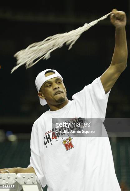 Juan Dixon of the University of Maryland Terrapins celebrates with a piece of the net after winning the men's NCAA National Championship game against...