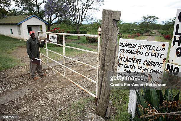 Security guard opens the gate on December 13, 2006 on Soysambu farm, Kenya. The 55,000-acre farm is owned by Delameres, the descendants of Rt. Hon....