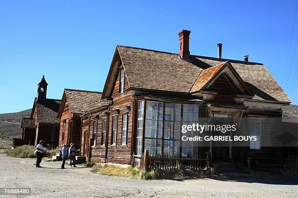 By Tangi QUEMENER, USA-MUSEUM-TOURISM-HISTORY Tourists tour the ghost town of Bodie, California, 12 September 2007. The government of California in...