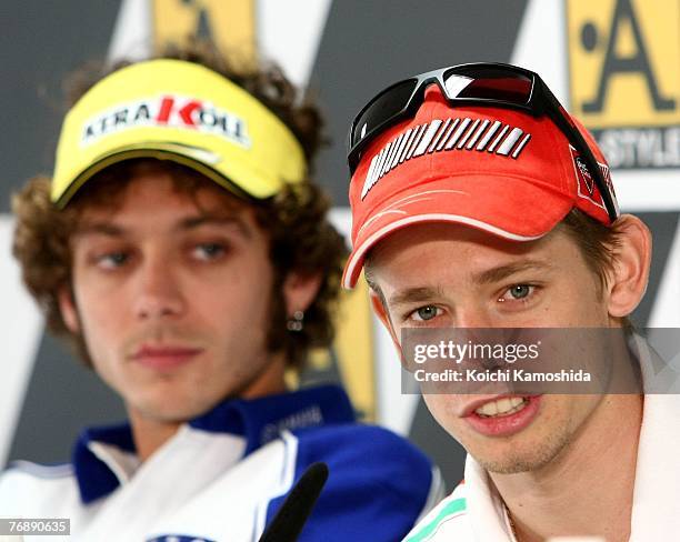 Casey Stoner of Australia and Ducati Marlboro team and Valentino Rossi of Italy and the Fiat Yamaha team attend a press conference during the...