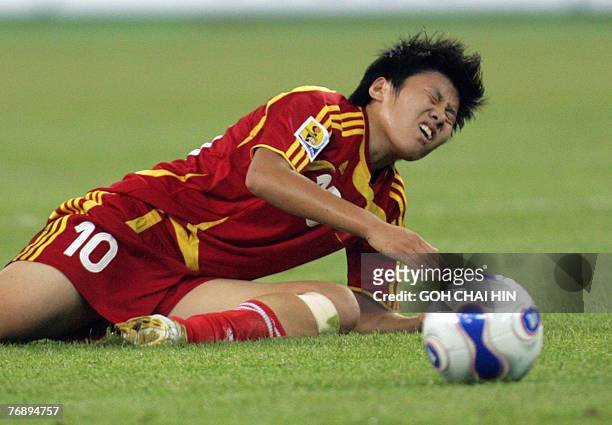 China's Ma Xiaoxu grimaces after she was brought down during the group B match against New Zealand, in the FIFA Women's World Cup football tournament...