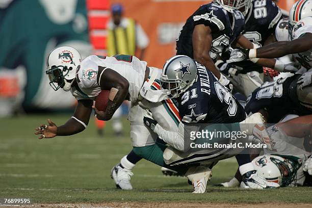 Ronnie Brown of the Miami Dolphins being caught from behind by Roy Williams of the Dallas Cowboys during a game at Dolphin Stadium on September 16,...