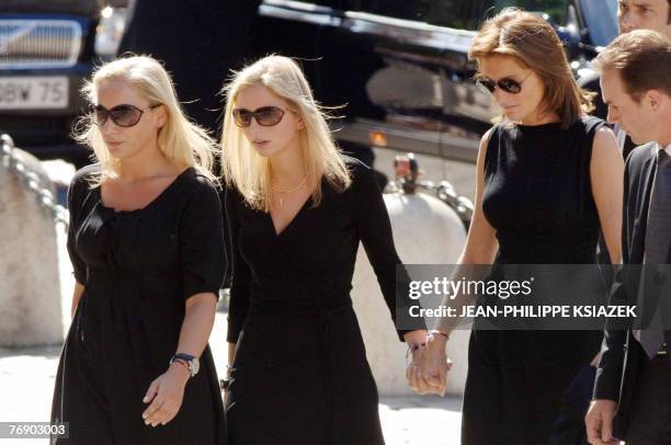 French first lady Cecilia Sarkozy arrives with her daughters Judith and Jeanne-Marie at the cathedral of Lyon, 20 September 2007, for the funeral of...