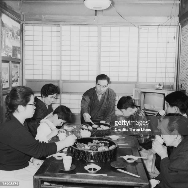 The Taguchi family sit down to breakfast in Japan, circa 1965.