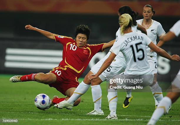 Ma Xiaoxu of China drives the ball, marked by Maia Jackman and New Zealand defenders during the FIFA Women's World Cup 2007 Group D match between...