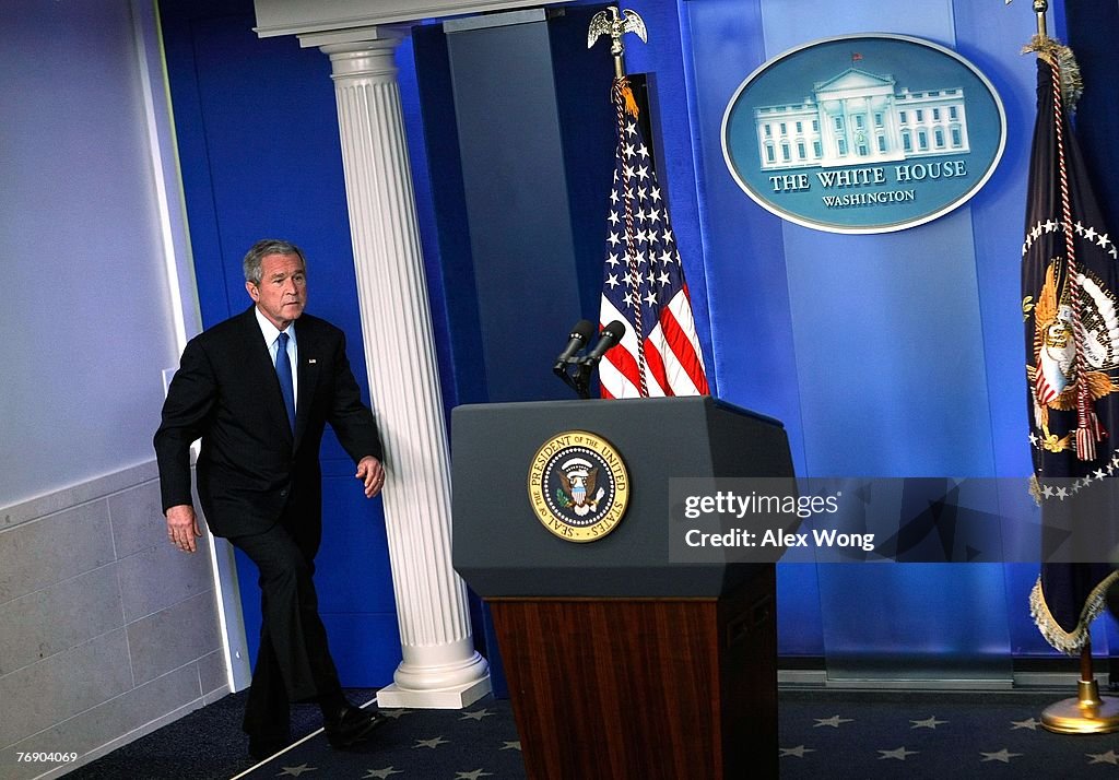 U.S. President W. Bush walks towards the podium for a news
