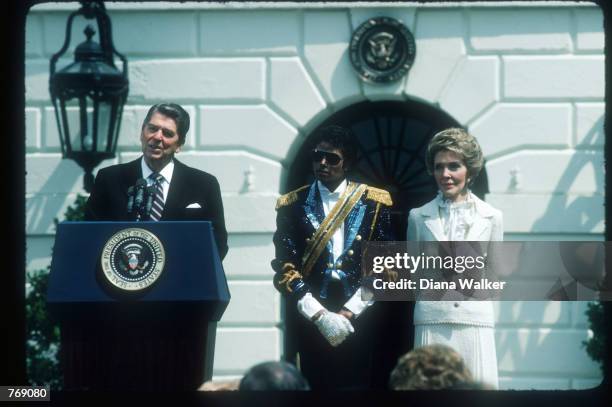 President Ronald Reagan speaks alongside wife Nancy and Michael Jackson May 4, 1984 at the White House. Jackson began singing professionally at the...