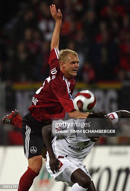 Nuernberg's defender Andreas Wolf and Bukarest's striker Pierre Boya vies for the ball during the the UEFA cup football match FC Nuremberg vs Rapid...