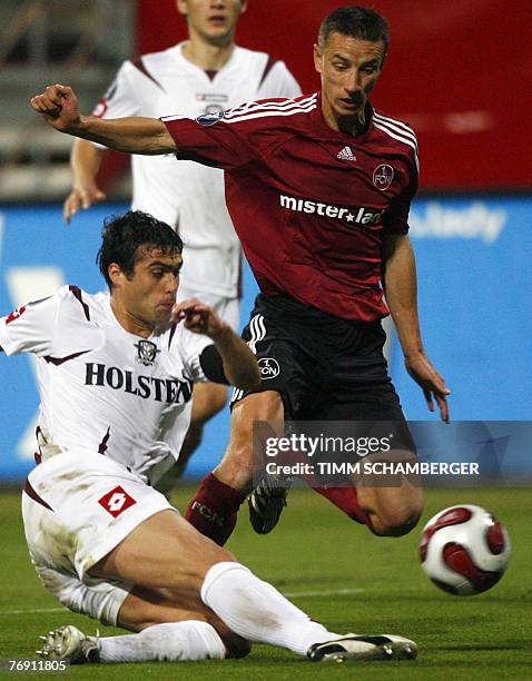 Nuernberg's Slovakian midfielder Marek Mintal and Bukarest's defender Vasile Maftei vies for the ball during the the UEFA cup football match FC...