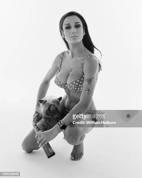 Spanish model Nati Abascal , in a polka-dot bikini, poses with a Shih Tzu on one leg and a soda bottle in one hand, New York, New York, 1968. She...