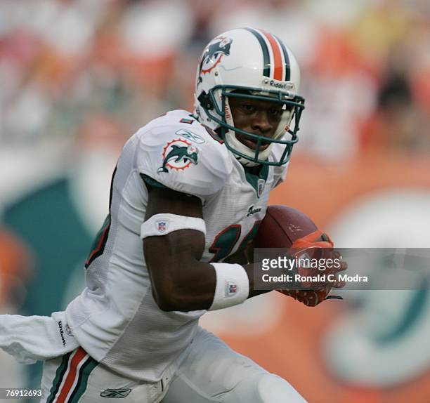 Ted Ginn Jr. #19 of the Miami Dolphins carries the ball during a game against the Dallas Cowboys at Dolphin Stadium on September 16, 2007 in Miami,...