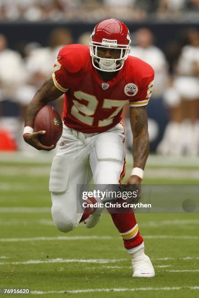 Larry Johnson of the Kansas City Chiefs runs past DeMarcus Faggins and DeMeco Ryans of the Houston Texans on September 9, 2007 at Reliant Stadium in...