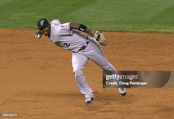 Shortstop Hanley Ramirez of the Florida Marlins makes a barehanded stop and throws out Matt Holliday of the Colorado Rockies in the fifth inning at...