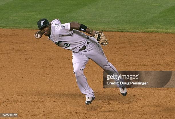 Shortstop Hanley Ramirez of the Florida Marlins makes a barehanded stop and throws out Matt Holliday of the Colorado Rockies in the fifth inning at...