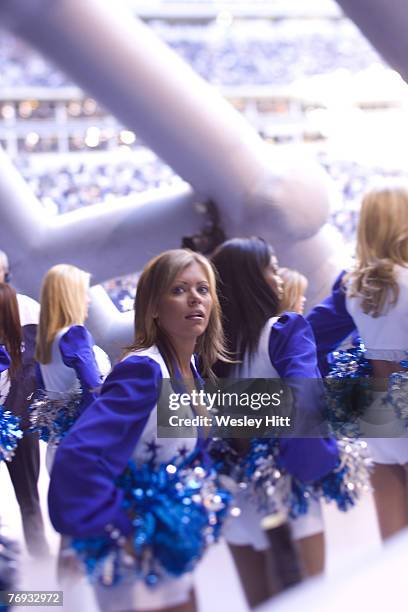 Dallas Cowboys cheerleader looks into the stands before a 27 to 13 loss to the New Orleans Saints on December 12, 2004 at Texas Stadium in Irving,...