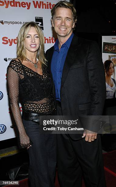 John Schneider and wife Elly Castle pose for a picture at the world premiere of 'Sydney White' at the Mann Bruin Theatre on September 20, 2007 in...