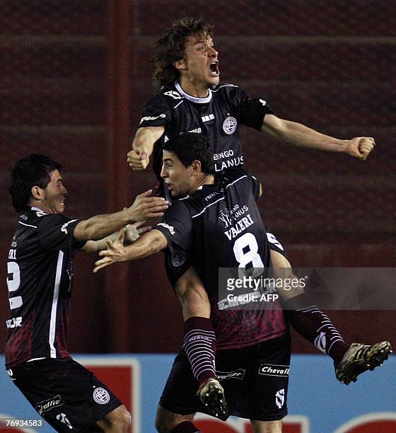 Lanus' midfielder Agustin Pelletieri celebrates with his teammates Diego Valeri and Santiago Biglieri after scoring against Vasco Da Gama, during...