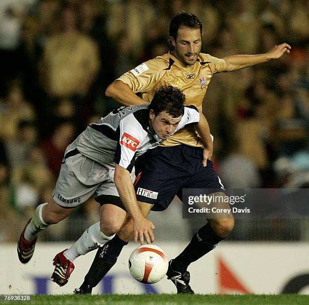 Andrew Durante of the Jets tackles Leigh Broxham of the Victory during the round five A-League match between the Newcastle Jets and the Melbourne...