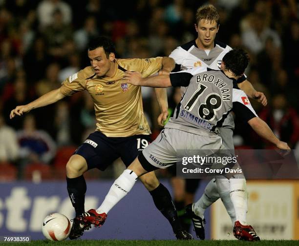 Mark Bridge of the Jets and Leigh Broxham of the Victory contest the ball during the round five A-League match between the Newcastle Jets and the...