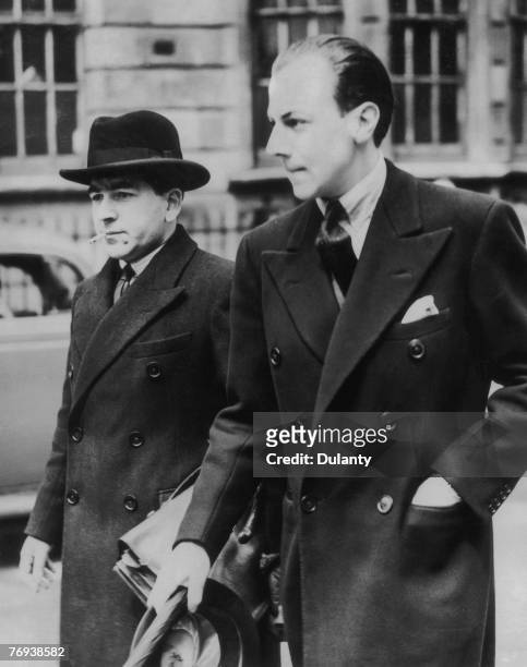 Victor Hervey, 6th Marquis of Bristol, right, outside court in Marlborough Street after a hearing on charges of jewel theft, 16th May 1939. He was...