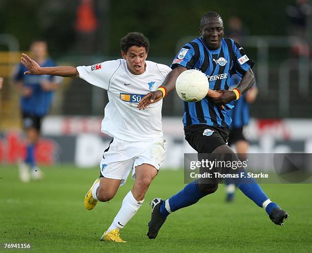 Carlos Eduardo Marques of Hoffenheim and Marc Gouiffe a Goufan of Paderborn tackle for the ball during the 2nd Bundesliga match between SC Paderborn...