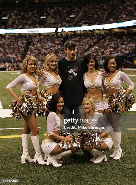 Singer Harry Connick Jr. Poses with cheerleaders after singing the National Anthem during a game between the New Orleans Saints and the Washington...