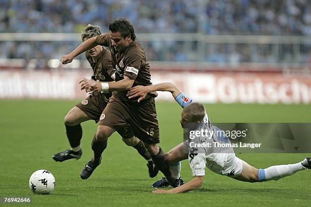 Alexander Ludwig, Bjoern Brunnemann of St Pauli and Lards Bender of Munich battle for the ball during the 2nd Bundesliga match between TSV 1860...