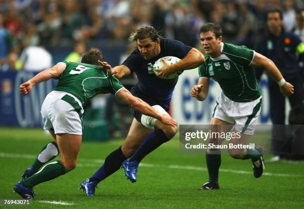 Cedric Heymans of France hands off Eoin Reddan of Ireland during the Rugby World Cup 2007 Pool D match between France and Ireland at the Stade de...