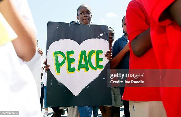 Sylvier Jean-Charles holds a peace sign as she participates in The International Day of Peace September 21, 2007 in Miami, Florida. The peace...