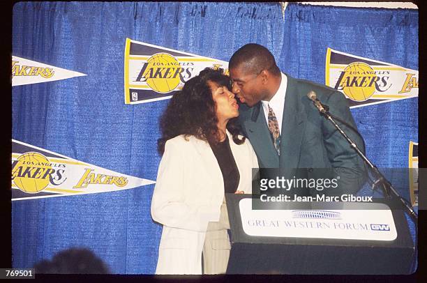 Earvin "Magic" Johnson kisses his wife at a press conference September 29, 1992 in Los Angeles, CA. Johnson won five championships and three Most...