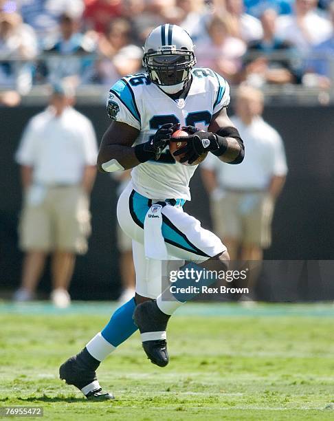 DeShaun Foster of the Carolina Panthers carries for a first down against the Houston Texans at Bank of America Stadium on September 16, 2007 in...