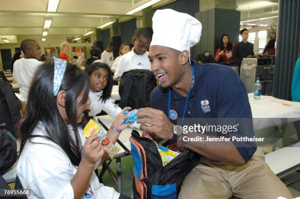 Al Horford of the Atlanta Hawks goes through the lunch bag with treats during the Rookie Transition Program NBA Cares Event at Public School 83 Luis...
