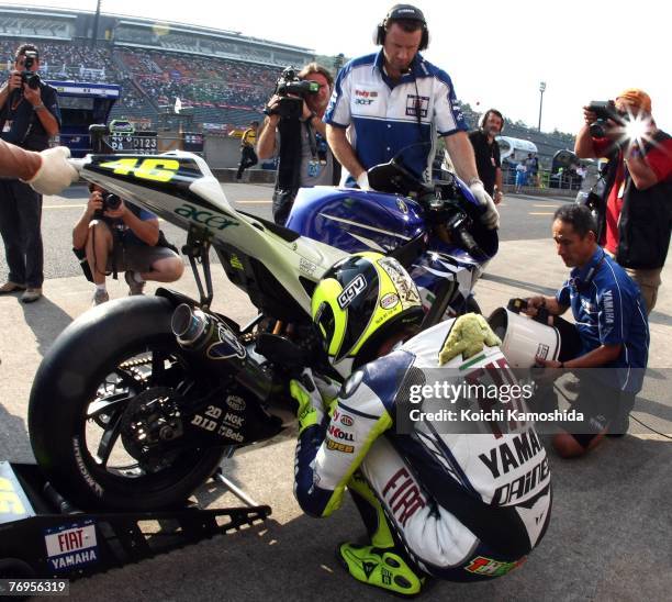 Valentino Rossi of Italy and the Fiat Yamaha team looks over his bike in the pits during the qualifying session for Round 15 of the 2007 MotoGP World...