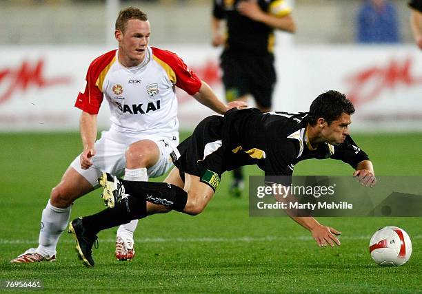 Felipe of the Phoenix takes a fall as Kristian Sarkies of Adelaide looks on during the round five A-League match between the Wellington Phoenix and...