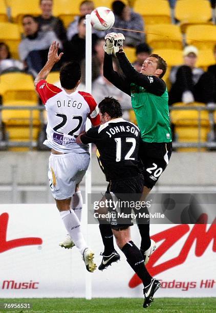 Glen Moss of the Phoenix clears the ball ahead of team mate Richard Johnson and Diego Walsh of Adelaide during the round five A-League match between...