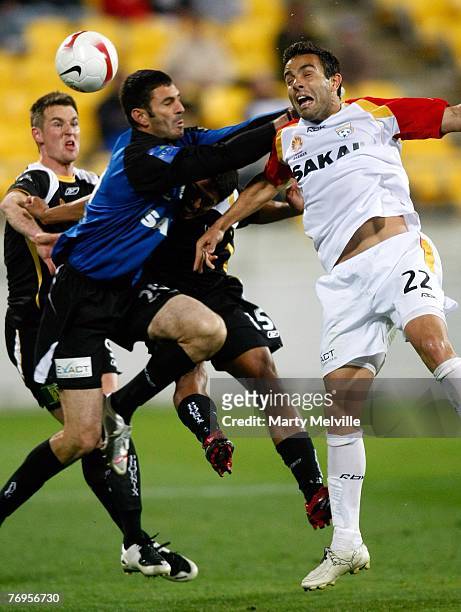 Diego Walsh of Adelaide is challenged in the air by Robert Bajic of the Phoenix during the round five A-League match between the Wellington Phoenix...